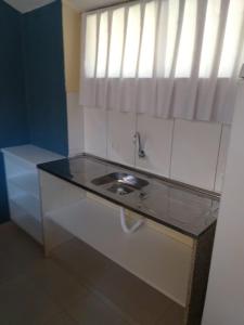 La salle de bains est pourvue d'un lavabo et d'une fenêtre. dans l'établissement Resort Campo Belo, à Álvares Machado