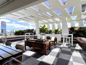 a rooftop patio with tables and chairs on a building at Southbank One Bedroom Home with Free Parking in Brisbane