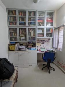 an office with a desk and a blue chair at Soul House_4.5 BHK Apartment in Ahmedabad