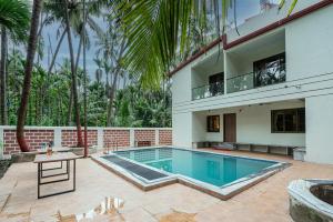 an exterior view of a house with a swimming pool at Beach Heaven Villa, Nandgaon in Murud