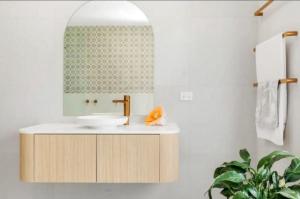 a bathroom with a sink and a mirror at Ocean Lake Oasis in Wamberal