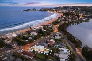 an aerial view of a beach with houses and the ocean at Ocean Lake Oasis in Wamberal