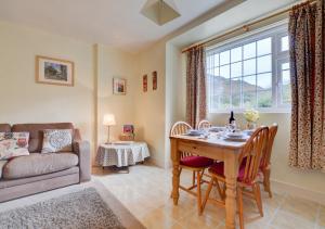 a living room with a table and a couch at Norbury in Penmaen-mawr