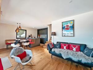 a living room with a couch and a dining room at Mirador Lodge - Crans Montana - Swiss Alps in Crans-Montana