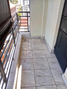 an empty balcony with a door and a sidewalk at Muthiga Springs Apartment in Kikuyu