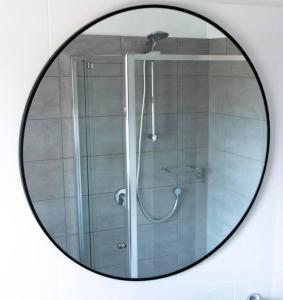a mirror reflecting a shower in a bathroom at Entire house in Minnipa - 3 bedroom, sleeps 5 in Minnipa
