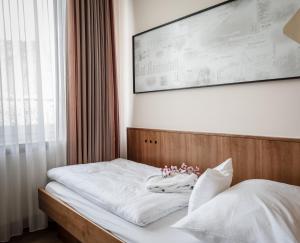 Postel nebo postele na pokoji v ubytování Alpenstadthotels