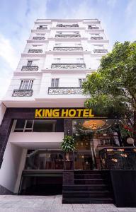 a white building with a king hotel sign on it at King Hotel Saigon Airport in Ho Chi Minh City