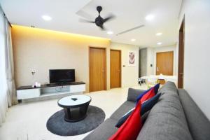 a living room with a couch and a tv at Vortex Suite & Residence Kuala Lumpur in Kuala Lumpur