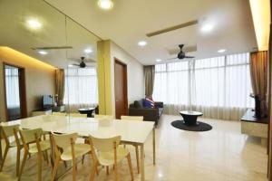 a dining room and living room with a table and chairs at Vortex Suite & Residence Kuala Lumpur in Kuala Lumpur