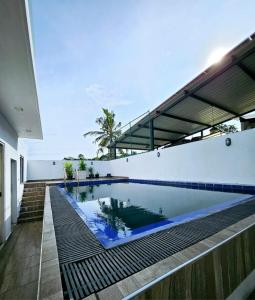 a swimming pool in the middle of a house at Villa 005 in Kirillapone