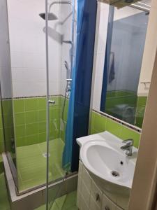 a bathroom with a sink and a glass shower at ЖК Сункар in Almaty