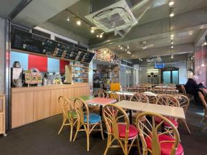 a restaurant with tables and chairs and a counter at Sakura Hostel Asakusa in Tokyo