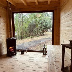 a screened in porch with a fireplace and a large window at NatureMugello Oasi Naturista in Dicomano