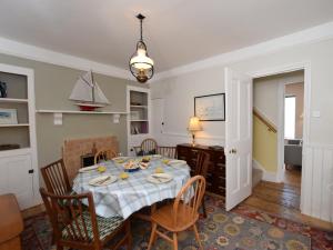 a dining room with a table and chairs at 3 bed property in Brixham BX045 in Brixham