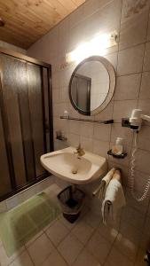 a bathroom with a sink and a shower at Gästehaus Christoph in Ried im Zillertal