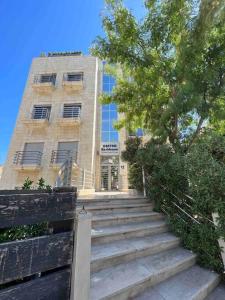 a building with stairs in front of a building at Spectacular 2 BR Apt in Jabal Amman 4th circle in Amman