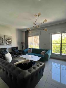 a living room with a couch and a table at Spectacular 2 BR Apt in Jabal Amman 4th circle in Amman