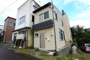 une maison assise sur le côté d'une rue dans l'établissement Sun River Annex Inaho - Vacation STAY 95961, à Kita-hamachō