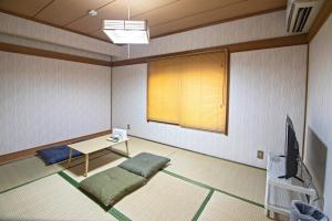 a room with a table and a tv in it at - Miyu Tsuruno 鶴野 - 新深江駅 in Osaka