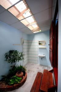 a bathroom with a skylight and a plant in a room at Baan Pongam Resort in Ao Nang Beach