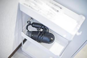 a hair dryer in a drawer in a kitchen at 山house中津 最大10人 中津駅まで徒歩6分 梅田まで電車4分行ける！　 in Osaka