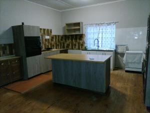 a kitchen with a island in the middle of a room at Karoo C in Beaufort West