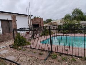 a fence in front of a swimming pool at Karoo C in Beaufort West