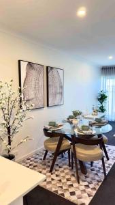 a dining room with a table and some chairs at Stylish modern 2 BR in Lawson in Belconnen