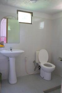 bagno con servizi igienici bianchi e lavandino di Mango House a Talalla South