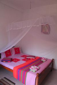a bedroom with a bed with a canopy at Mango House in Talalla