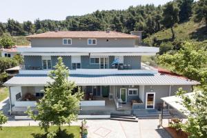 a large house with a hill in the background at Istira in Possidi