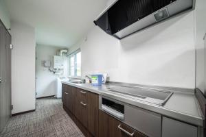 a kitchen with a sink and a counter top at THE NORTH PEAK 202 in Furano