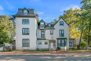 a large white house with a black roof at Beautiful 2bdrm Large Flat Univ City in Philadelphia