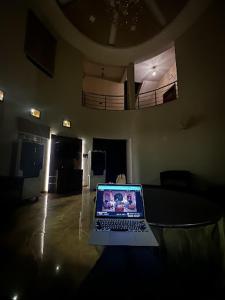 a laptop computer sitting on a table in a room at Ishara villa in Indore