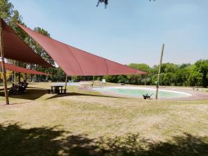 a picnic shelter with a picnic table and a park at The View on Vaal Resort in Sasolburg