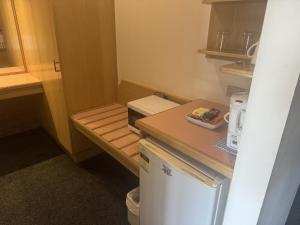 a small kitchen with a refrigerator and a counter at Charles sturt motor inn in Cobram