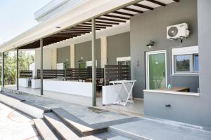 a patio with a row of benches on a building at Istira in Possidi