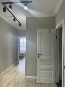 an empty room with a white door and a bedroom at ЖК Only Sun in Prigorodnyy