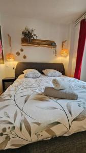 a bed in a bedroom with two pillows on it at Le Royat Palace #Therme#Confort - Meublé classé 3étoiles in Royat