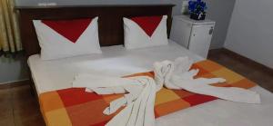 a bed with a person made out of whiteadobeadobeadobe at Ocean Villa in Panadura