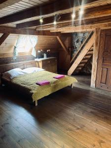 a bedroom with a bed in an attic at Agroturystyka Agro-Podkówka in Marciszów