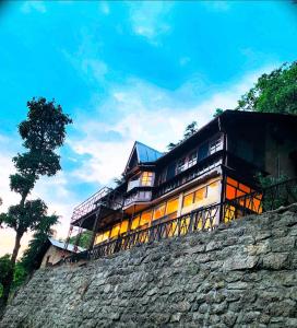 a house on top of a stone wall at Carabean Villa in Dalhousie