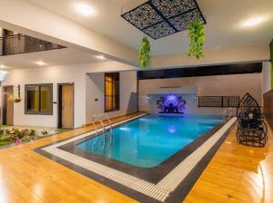 a large swimming pool in a large room at Skilight Villa in Indore