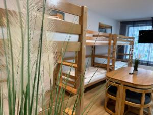 a room with two bunk beds and a table at Ferienwohnung in Center of Hamburg-Barmbek-Airport-4 in Hamburg