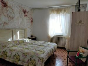 Schlafzimmer mit einem Bett und einem Fenster in der Unterkunft BnB La Casina dei Nonni in Campofilone