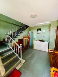 a staircase in a room with green walls at BT hotel Kata Beach in Kata Beach