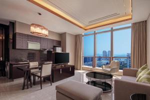 a living room with a kitchen and a dining room at Hilton Haikou in Haikou