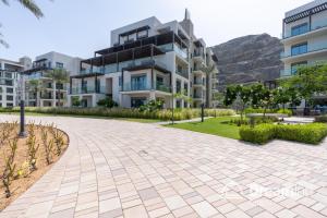 a walkway in front of a building at Dream Inn - Address Beach Residence - Free Beach Access in Fujairah