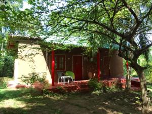 a small house with red decorations in front of it at Peacock Family Stay in Tangalle